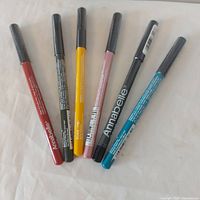 Six Annabelle eyeliners arranged on surface
