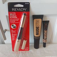 All three items: packaged Revlon jelly blender, Nudestix foundation tube, Nudestix concealer tube