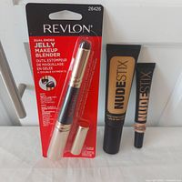 Group shot of Revlon blender package, Nudestix foundation and concealer tubes