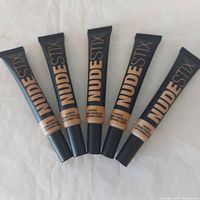 Five tubes of Nudestix Nudefix Cream Concealer upright showing branding