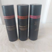 Three Nudestix blush sticks standing, labels visible