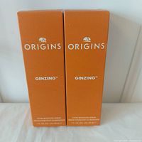 Front view of two boxed Origins Ginzing Glow Boosting Serums