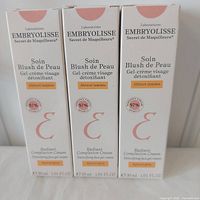 Front view three boxed Embryolisse Radiant Complexion Cream Apricot Glow 30 ml
