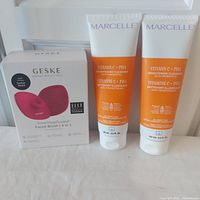 Front view of boxed Geske facial brush and two Marcelle cleanser tubes
