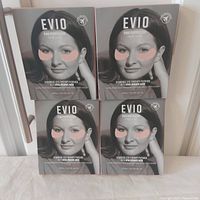 Front view of four Evio Beauty Pink Perspective Hydrogel Eye Therapy Patches boxes