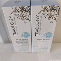 Front view of both boxed serums
