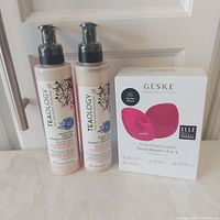 Two Teaology cleanser bottles and Geske facial brush box