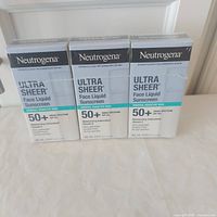 Front view of three boxed Neutrogena Ultra Sheer Face Liquid Sunscreens