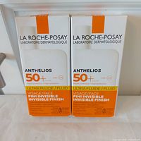 Front view of both boxed sunscreens