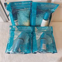 Four sealed St. Tropez tanning kits laid out