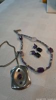 Overview of both necklaces and four earrings