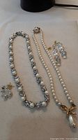 Group view of two necklaces and two earring pairs