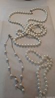 Overview of all three faux pearl necklaces laid out