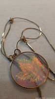 Close-up of holographic maple leaf image within pendant