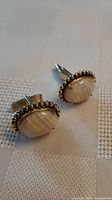 Front view of both cufflinks showing stone cabochons and beaded bezel