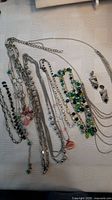 All necklaces and earrings laid out showing variety of styles and beads