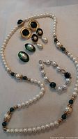 Full lot overview showing necklace, bracelet and four pairs of earrings