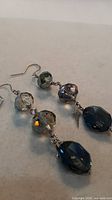 Full view of both earrings showing bead arrangement and dagger charm