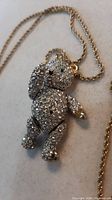 Close-up of rhinestone articulated teddy bear pendant necklace