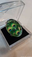 Ring in display box showing top cabochon design