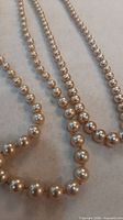 Close view of faux pearl beads showing colour and finish