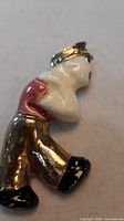 Front angled view of porcelain sailor brooch