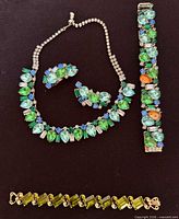 Full lot showing necklace, matching bracelet, earrings and Lisner bracelet
