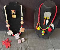 Overall shot showing both themed necklaces, earrings, brooch and bingo chips