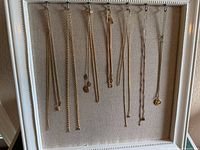All necklaces hanging on display frame