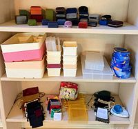 Full view of shelves showing jewelry boxes, bins, pouches