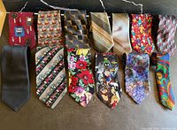All thirteen neckties laid out showing patterns and colours
