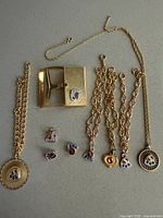 Group image of Safeway necklaces, money clip, charm bracelets and loose charms