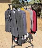 Front view of seven blazers on rolling rack