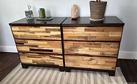 Frontal view of both dressers showing drawer fronts and tops