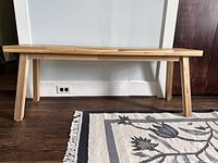 Front view of wooden bench against wall