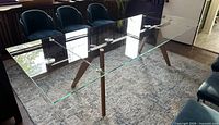 Full view of glass-top table showing entire structure and legs