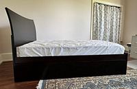 Side view of assembled bed frame showing dark espresso color, mattress placeholder and low profile