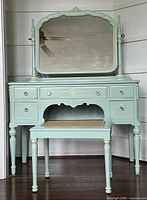 Full view of painted wood vanity, mirror, and bench