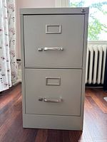 front view showing two drawers with handles, label frames and lock