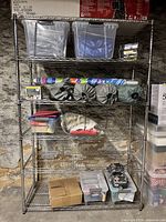 Front view of one rack showing six wire shelves loaded with items