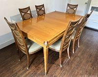 Table with six chairs, brass corners visible