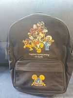 Front view showing character graphic, anniversary emblem and front pocket