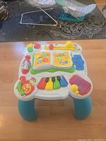 Full view of LeapFrog activity table standing on blue legs