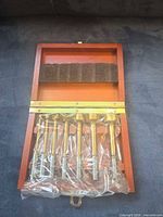Sealed drill bit set in wooden case