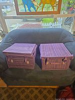 Two assembled purple striped storage bins on couch