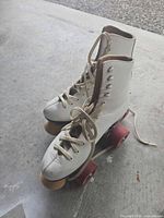 side view of both skates showing boots, wheels, laces