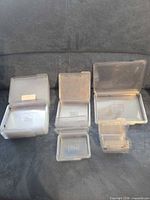 Front view showing several stacks of clear plastic Stampin' Up cases in multiple sizes