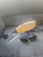 SteamXtreme handheld steam cleaner with attachments laid out