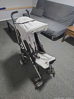 Full view of Britax folding stroller standing upright