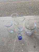 Group of six glass vases showing variety of shapes and sizes